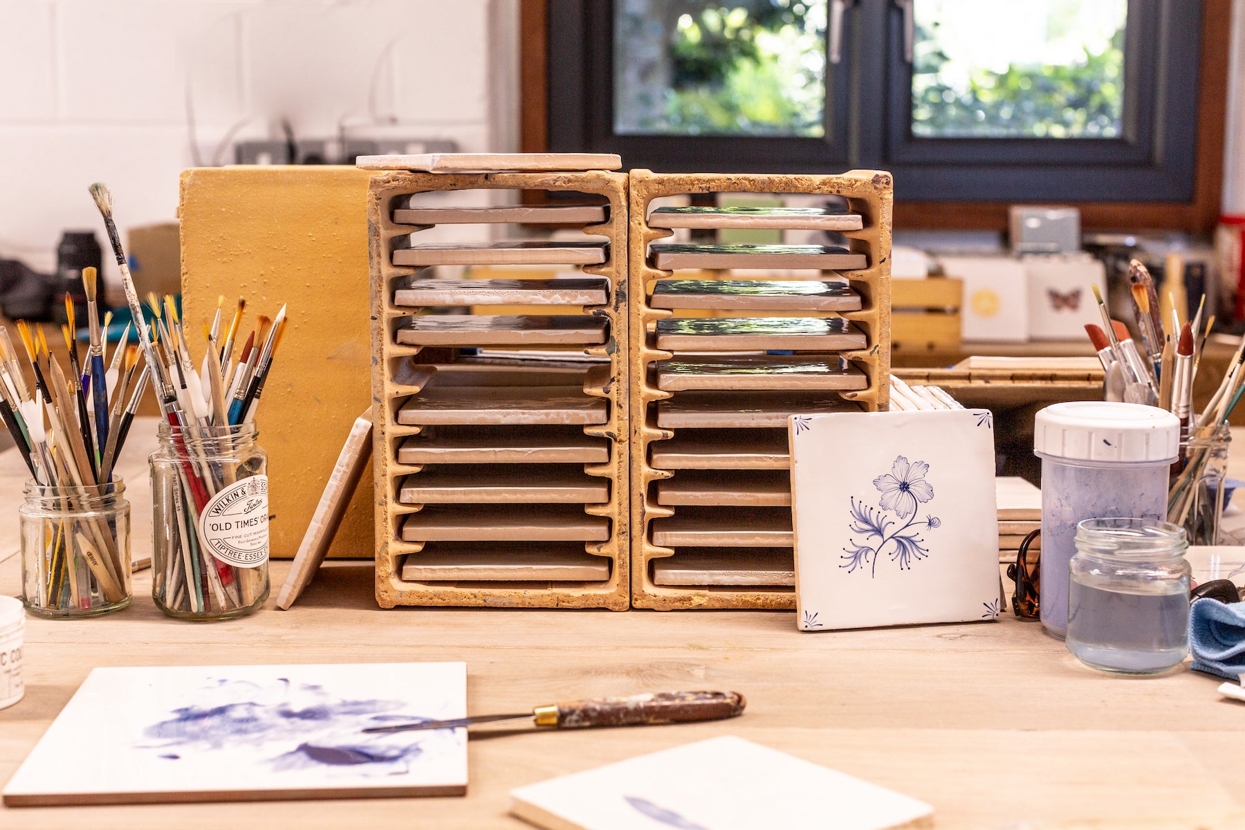 Hand painting tiles in Decorum Studio Cornwall
